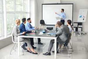 Businessman giving presentation during meeting in office