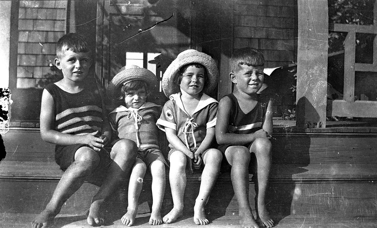 Joseph Kennedy Jr., Kathleen Kennedy, Rosemary Kennedy and John F. Kennedy in Cohasset. Copyright John F. Kennedy Library Foundation found in the John F. Kennedy Presidential Library and Museum, Boston. Scanned from the original 4" x 2 1/2" nitrate negative. Scanned by CTR on DAMS 2B.